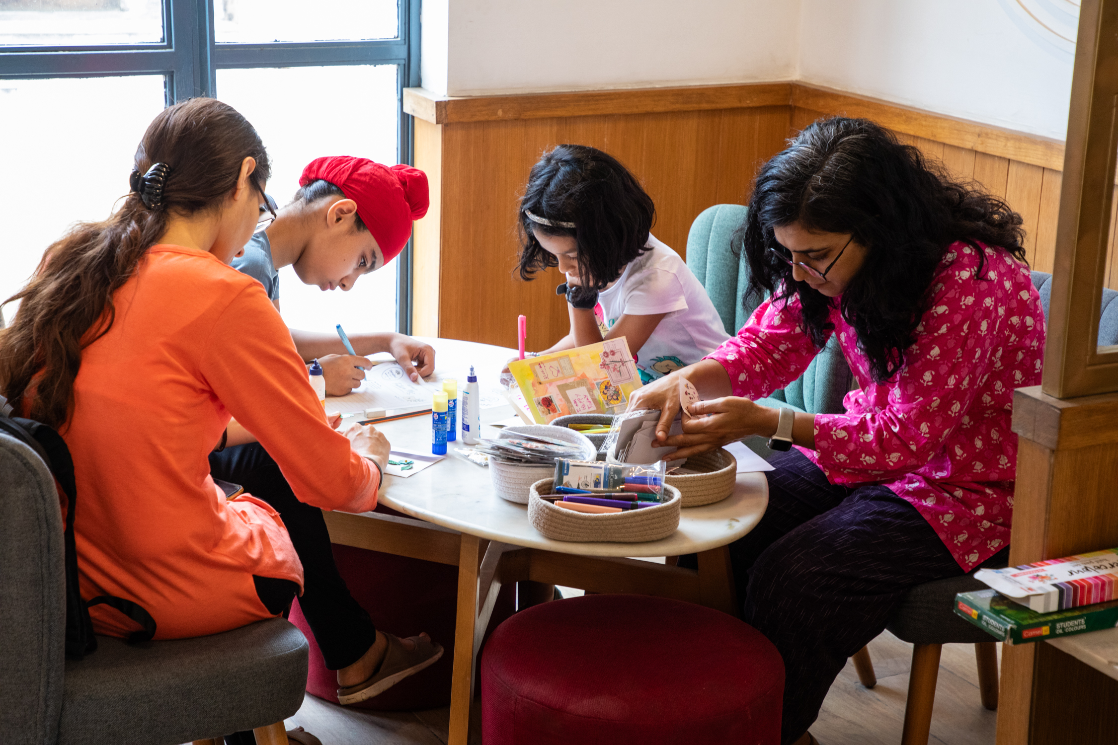 Group crafting session with journals and pens
